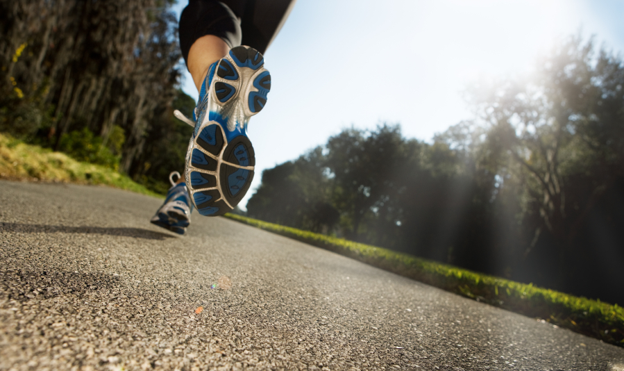 Runner on a road, viewed from behind